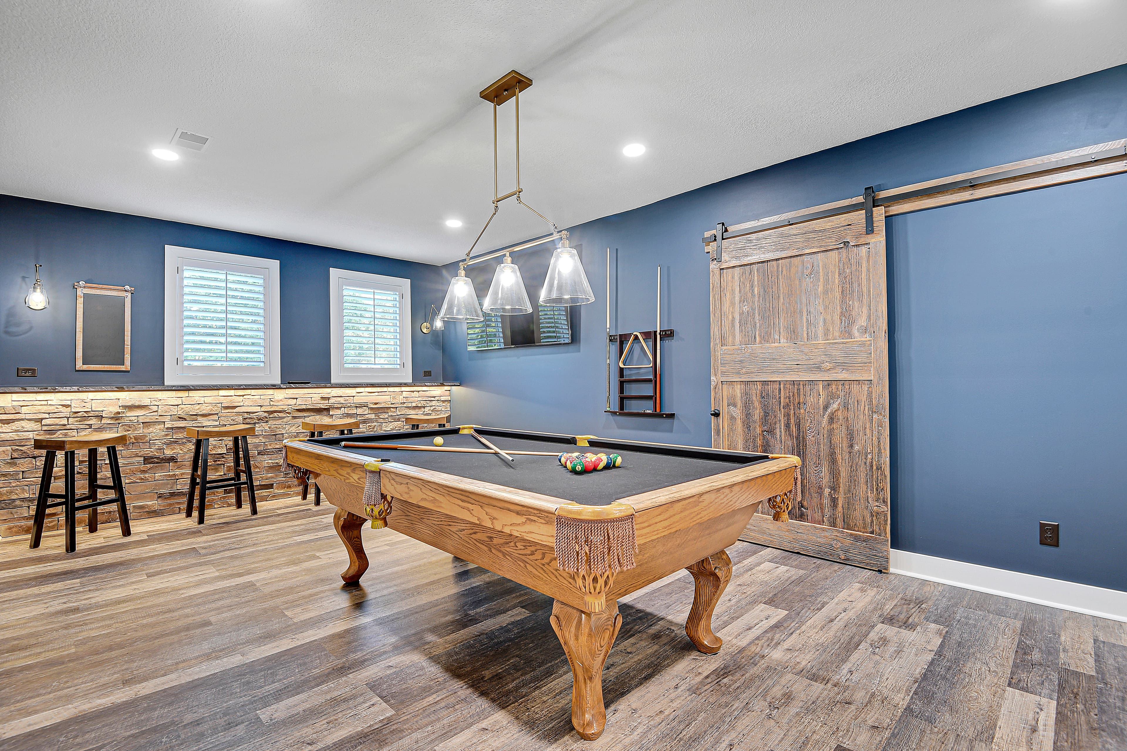 Finished game room staged with color and scale for an investor listing