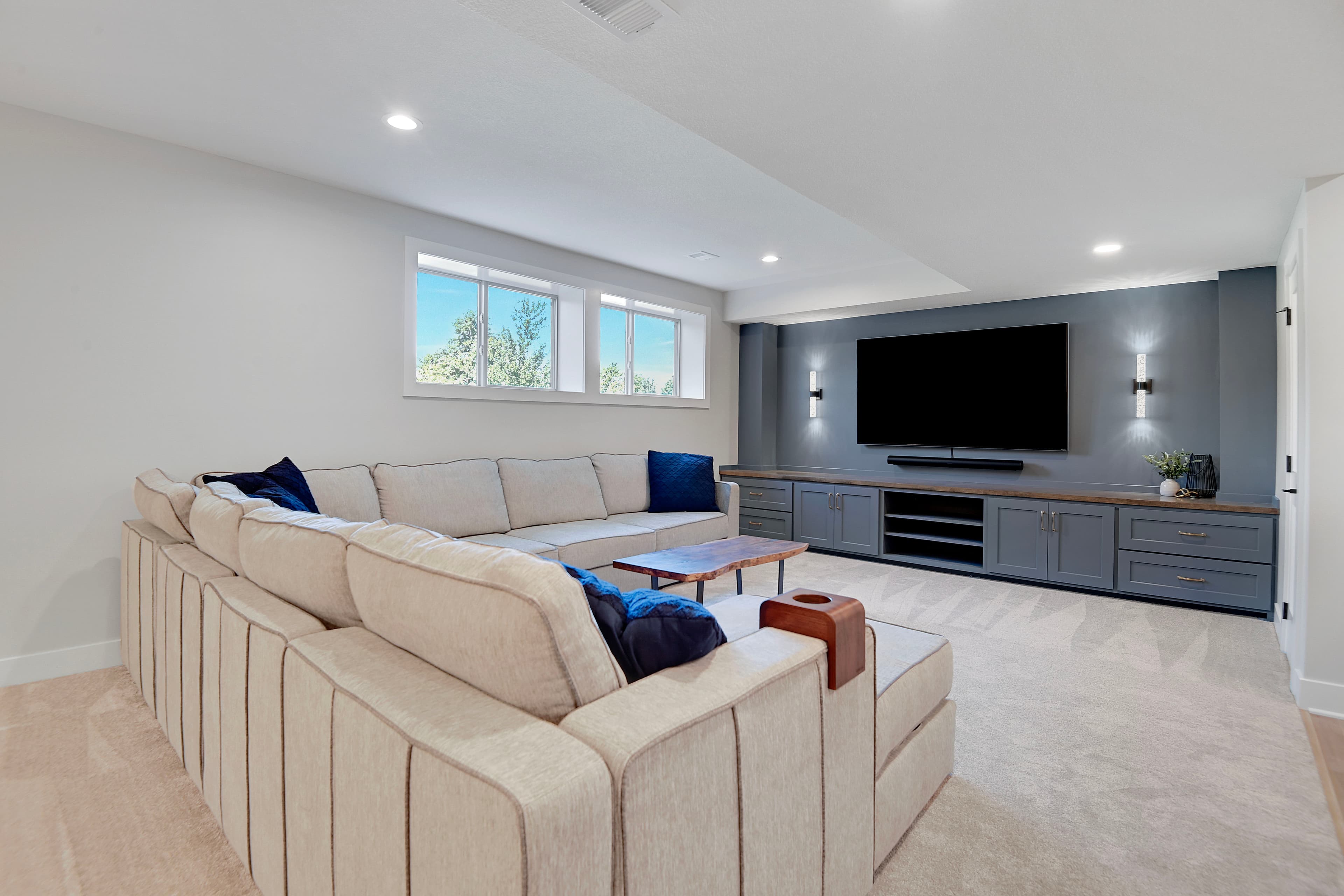 Cream sectional media room with a built-in entertainment wall