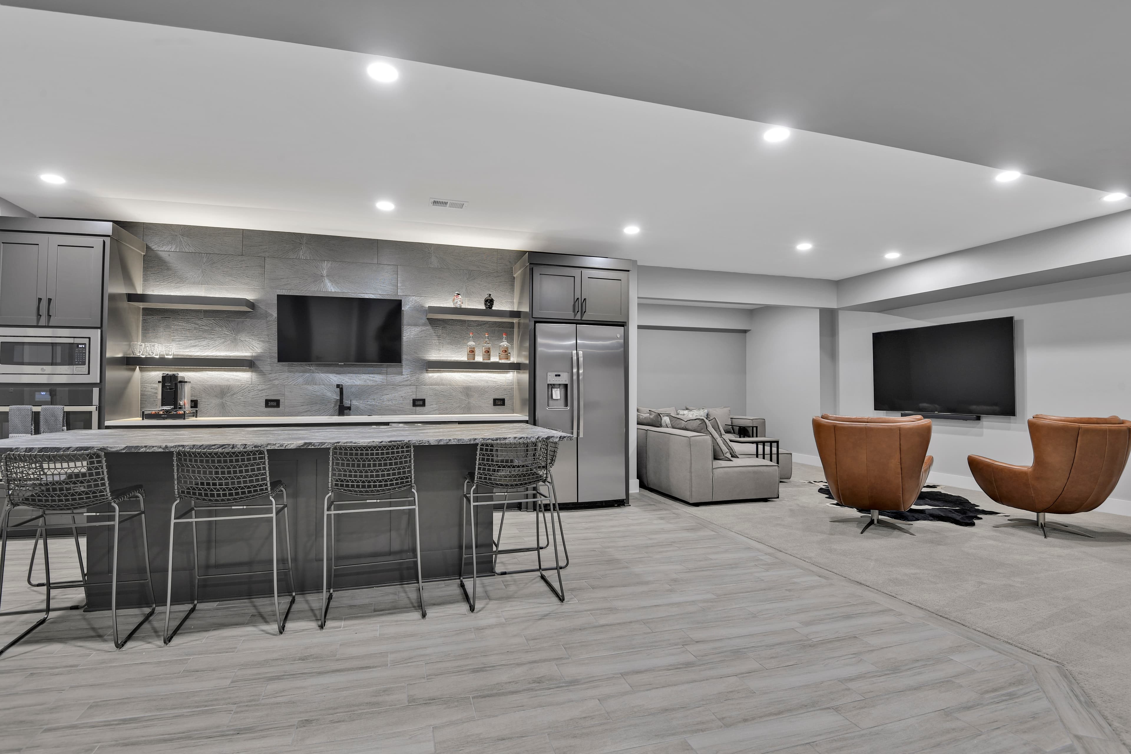 Modern lower-level bar and lounge with leather swivel chairs